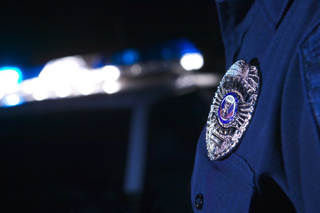 Close up image of the badge on the chest of an officer with a blurred-out background used on the Partners page.